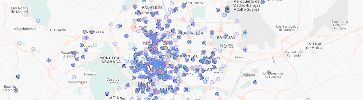 Map of Madrid covered with hundreds of blue, red and green dots of simulated riders and drivers, packed in the city centre and thinning out towards Barajas airport and the outskirts
